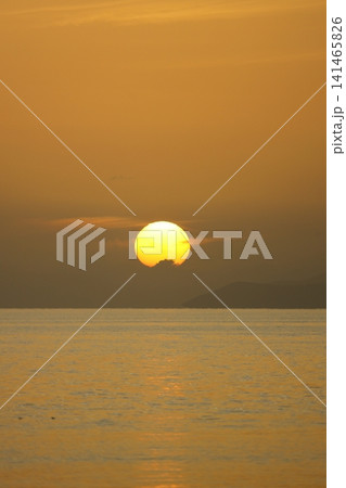 Close-up of empty sky and sun for copy space. The spectacular view of the sunset was breathtaking, with the sun sinking behind the clouds on the horizon. Close-up of empty sky and sun for copy space. The spectacular view of the sunset was breathtaking, with the sun sinking behind the clouds on the horizon. 141465826