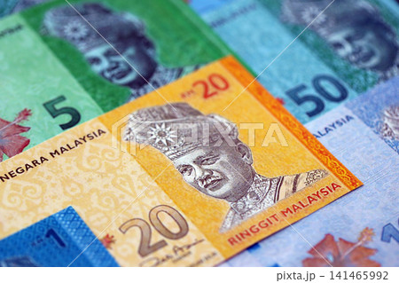 Malaysian ringgit paper banknotes pile on table. Malaysia MYR currency money bills in big amount Malaysian ringgit paper banknotes pile on table. Malaysia MYR currency money bills in big amount 141465992