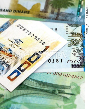 Algerian dinar paper banknotes pile on table. Algeria DZD currency money bills in big amount Algerian dinar paper banknotes pile on table. Algeria DZD currency money bills in big amount 141466008