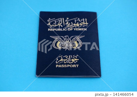 Yemeni passport on table close up. Official identification document book for citizens of Yemen Yemeni passport on table close up. Official identification document book for citizens of Yemen 141466054