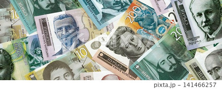 Serbian dinar money bills pile on table. Serbia banknotes of RSD currency. Concept of business Serbian dinar money bills pile on table. Serbia banknotes of RSD currency. Concept of business 141466257