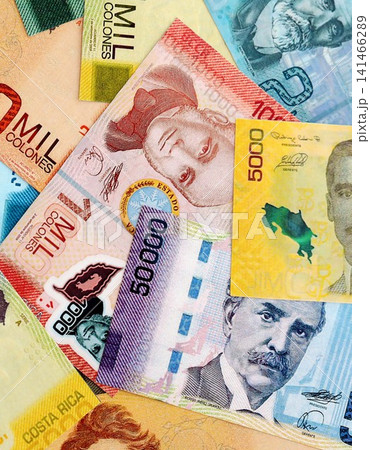 Costa Rican colon money bills pile on table. Costa Rica banknotes of CRC currency close up Costa Rican colon money bills pile on table. Costa Rica banknotes of CRC currency close up 141466289