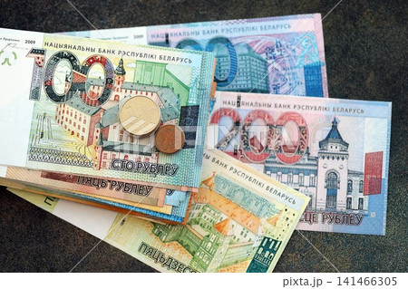 Belarusian ruble money bills and kopek coins pile. Belarus coins on banknotes of BYN currency 141466305