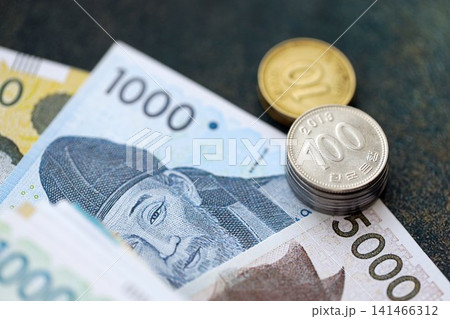 South Korean won money bills and jeon coins pile. South Korea coins on banknotes of KRW currency South Korean won money bills and jeon coins pile. South Korea coins on banknotes of KRW currency 141466312