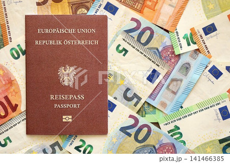 Austria passport lies on big amount of euro money banknotes. Rich life and travel in Europe Austria passport lies on big amount of euro money banknotes. Rich life and travel in Europe 141466385
