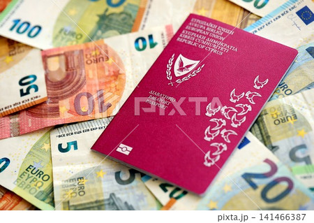 Kyprus passport lies on big amount of euro money banknotes. Rich life and travel in Europe Kyprus passport lies on big amount of euro money banknotes. Rich life and travel in Europe 141466387
