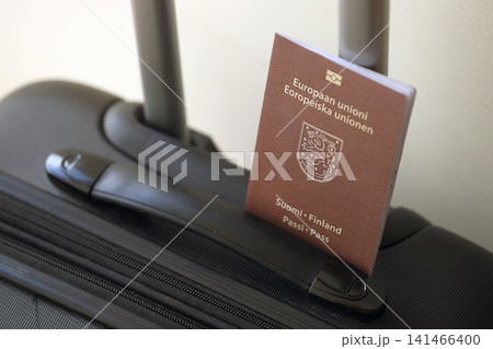 Finland passport on touristic baggage luggage in airport. Travel and tourism in Europe concept Finland passport on touristic baggage luggage in airport. Travel and tourism in Europe concept 141466400