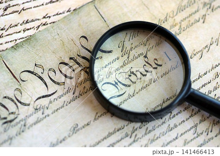 Magnifying glass and United States Constitution. American USA Constitution paper page and loupe Magnifying glass and United States Constitution. American USA Constitution paper page and loupe 141466413