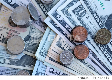 Half Dollar and one dollar coins on top of USD banknotes. Coins and paper money 141466415