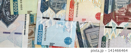 Uzbek som money bills pile on table. Uzbekistan banknotes of UZN currency close up Uzbek som money bills pile on table. Uzbekistan banknotes of UZN currency close up 141466464