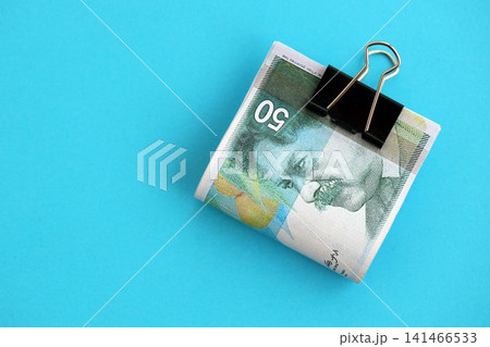Israel New Shekels banknotes on blue background. The current Israel money bills lies on blue 141466533
