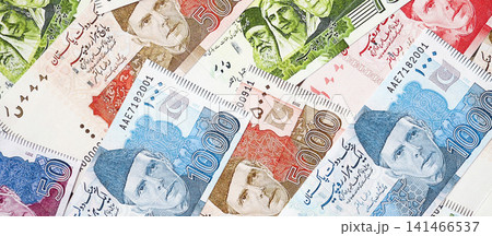 Pakistan rupees banknotes. The current Pakistan money bills lies on table in big amount Pakistan rupees banknotes. The current Pakistan money bills lies on table in big amount 141466537