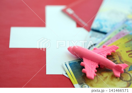 Swiss franc banknotes and passport with tickets on flag. The current francs money bills and pass 141466571