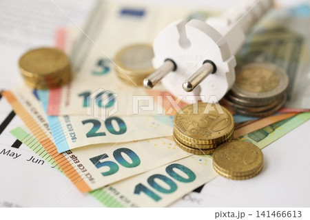 European union Euro money bills and coins with european electricity utility bill on table 141466613