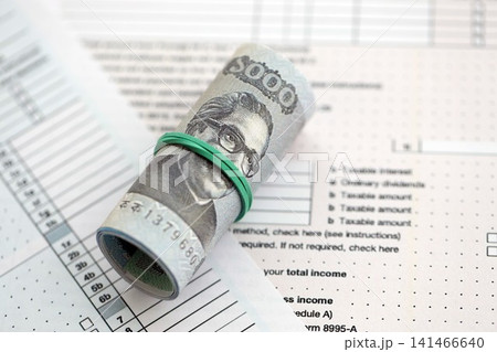 Bangladeshi taka money bills in big amount lies on table with tax forms close up Bangladeshi taka money bills in big amount lies on table with tax forms close up 141466640