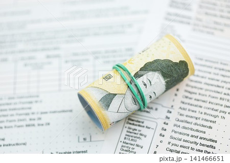 South Korean won money bills in big amount lies on table with tax forms close up South Korean won money bills in big amount lies on table with tax forms close up 141466651