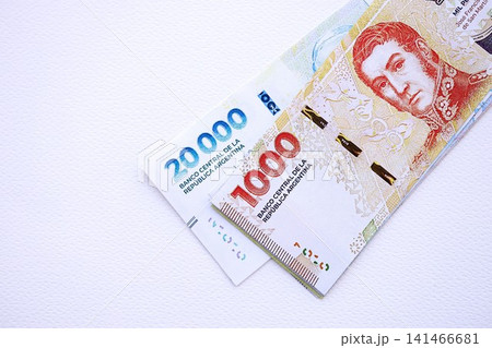 Argentine pesos money bills in big amount lies on white table close up Argentine pesos money bills in big amount lies on white table close up 141466681