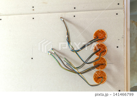 New electrical installation, socket plastic boxes and electrical cables on the wall, renovation concept. Electrical wiring installation. New electrical installation, socket plastic boxes and electrical cables on the wall, renovation concept. Electrical wiring installation. 141466799