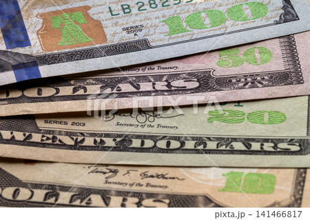 Money, prosperity and finances concept. Abstract light background of American USA national currency banknotes, details of neatly stacked bills worth one hundred dollars. Money, prosperity and finances concept. Abstract light background of American USA national currency banknotes, details of neatly stacked bills worth one hundred dollars. 141466817