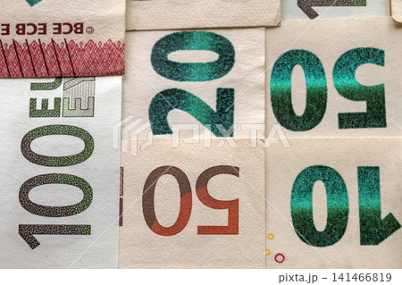 Money and finances concept. Bright colorful abstract surface, background of euro national currency different bills. Banknotes worth ten, twenty, fifty, hundred and two hundred euro. Money and finances concept. Bright colorful abstract surface, background of euro national currency different bills. Banknotes worth ten, twenty, fifty, hundred and two hundred euro. 141466819