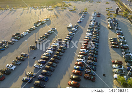 Large parking lot of local dealer with many brand new cars parked for sale. Development of american automotive industry and distribution of manufactured vehicles concept 141466882