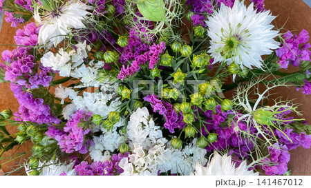 Wildflower bouquet with white nigella and purple limonium in craft paper Wildflower bouquet with white nigella and purple limonium in craft paper 141467012