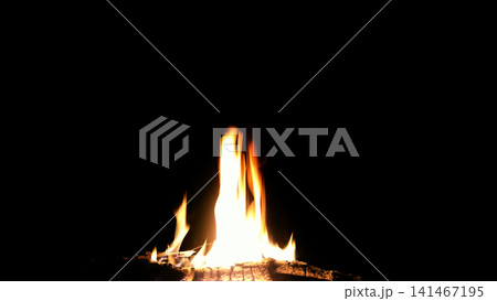 The hot embers of burning wood log fire isolated on black. Firewood burning on stove. The hot embers of burning wood log fire isolated on black. Firewood burning on stove. 141467195