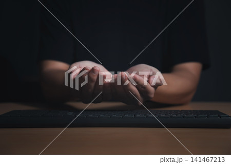 Male empty hands open palms up over computer keyboard on dark background. Male empty hands open palms up over computer keyboard on dark background. 141467213