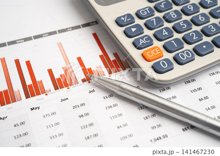 Calculator with pen on data business graphs paper. Calculator with pen on data business graphs paper. 141467230