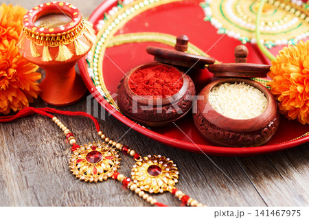 Raksha bandhan thali with rakhi and sacred items 141467975