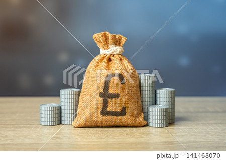 A british pound money bag and stacks of coins. Financial budget. Salaries and pensions. Financial resources. Savings and deposits. A british pound money bag and stacks of coins. Financial budget. Salaries and pensions. Financial resources. Savings and deposits. 141468070