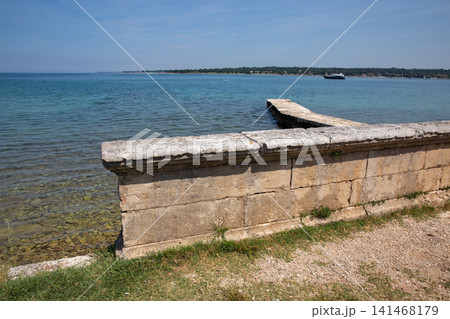 Stone retaining wall by the Adriatic Sea in Istria, Croatia. Stone retaining wall by the Adriatic Sea in Istria, Croatia. 141468179