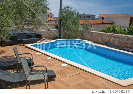 Modern swimming pool with lounge chairs in Croatia. Modern swimming pool with lounge chairs in Croatia. 141468187
