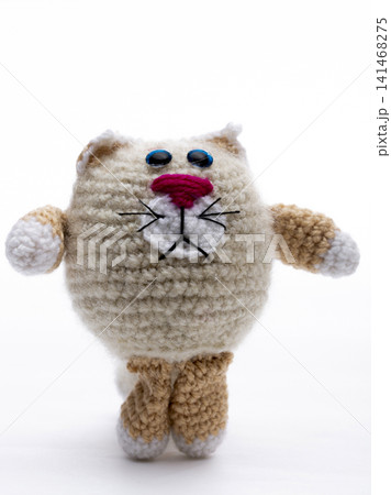 Knitted cat on a white background Knitted cat on a white background 141468275