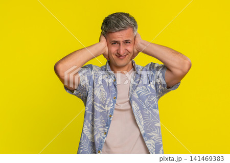 Adult man covering ears and shaking head with denial refusing to hear anything with strong rejection Adult man covering ears and shaking head with denial refusing to hear anything with strong rejection 141469383