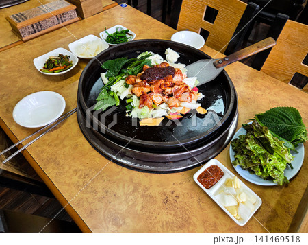 Spicy Korean Chicken Stir Fry Dakgalbi with Vegetables on Iron Pan 141469518