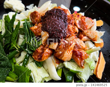Spicy Korean Chicken Stir Fry Dakgalbi with Vegetables on Iron Pan Spicy Korean Chicken Stir Fry Dakgalbi with Vegetables on Iron Pan 141469525