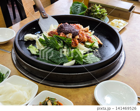 Spicy Korean Chicken Stir Fry Dakgalbi with Vegetables on Iron Pan Spicy Korean Chicken Stir Fry Dakgalbi with Vegetables on Iron Pan 141469526