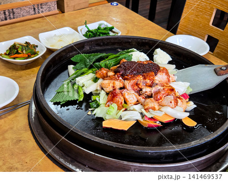 Spicy Korean Chicken Stir Fry Dakgalbi with Vegetables on Iron Pan Spicy Korean Chicken Stir Fry Dakgalbi with Vegetables on Iron Pan 141469537