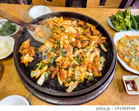 Spicy Korean Chicken Stir Fry Dakgalbi with Vegetables on Iron Pan Spicy Korean Chicken Stir Fry Dakgalbi with Vegetables on Iron Pan 141469546
