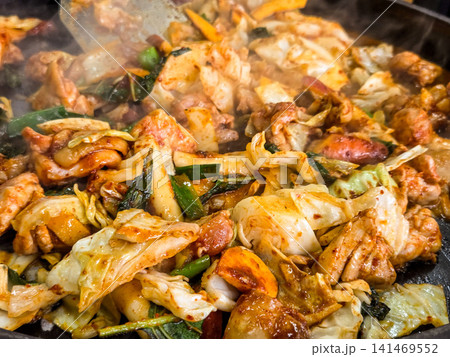 Spicy Korean Chicken Stir Fry Dakgalbi with Vegetables on Iron Pan Spicy Korean Chicken Stir Fry Dakgalbi with Vegetables on Iron Pan 141469552