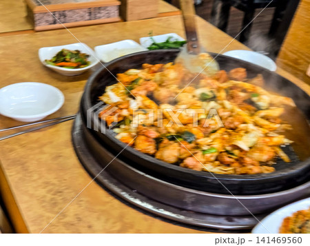 Spicy Korean Chicken Stir Fry Dakgalbi with Vegetables on Iron Pan Spicy Korean Chicken Stir Fry Dakgalbi with Vegetables on Iron Pan 141469560