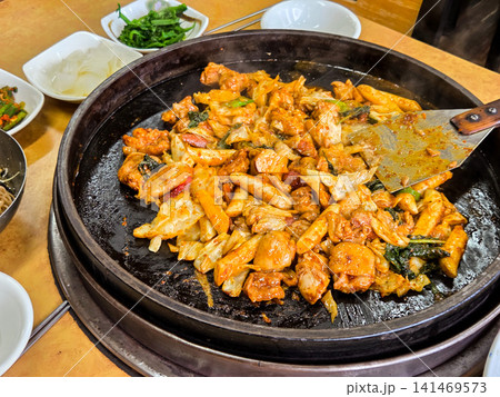 Spicy Korean Chicken Stir Fry Dakgalbi with Vegetables on Iron Pan Spicy Korean Chicken Stir Fry Dakgalbi with Vegetables on Iron Pan 141469573