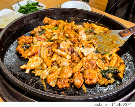Spicy Korean Chicken Stir Fry Dakgalbi with Vegetables on Iron Pan Spicy Korean Chicken Stir Fry Dakgalbi with Vegetables on Iron Pan 141469574