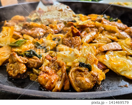 Spicy Korean Chicken Stir Fry Dakgalbi with Vegetables on Iron Pan Spicy Korean Chicken Stir Fry Dakgalbi with Vegetables on Iron Pan 141469579