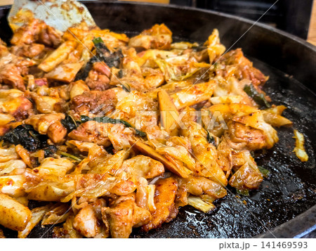 Spicy Korean Chicken Stir Fry Dakgalbi with Vegetables on Iron Pan Spicy Korean Chicken Stir Fry Dakgalbi with Vegetables on Iron Pan 141469593