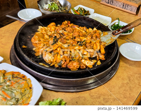 Spicy Korean Chicken Stir Fry Dakgalbi with Vegetables on Iron Pan 141469599
