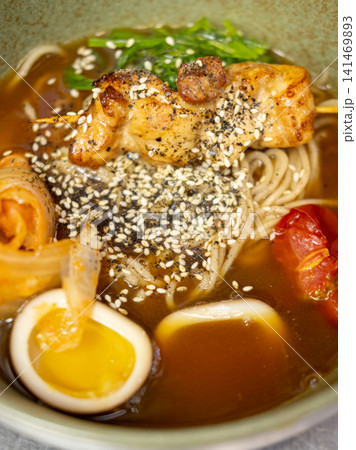 Asian dish. Miso soup. Colorful spaghetti with meat egg vegetable sesame spicy. Appetizing nutrition meal with cabbage tomato green seaweed. Asian dish. Miso soup. Colorful spaghetti with meat egg vegetable sesame spicy. Appetizing nutrition meal with cabbage tomato green seaweed. 141469893