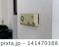 Vintage analog thermostat mounted on a white textured wall 141470388