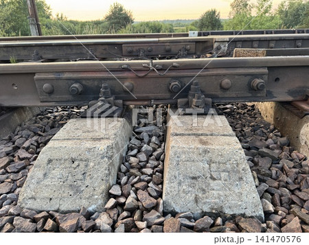 Sturdy Railway Tracks with Concrete Sleepers at Golden Hour Sturdy Railway Tracks with Concrete Sleepers at Golden Hour 141470576